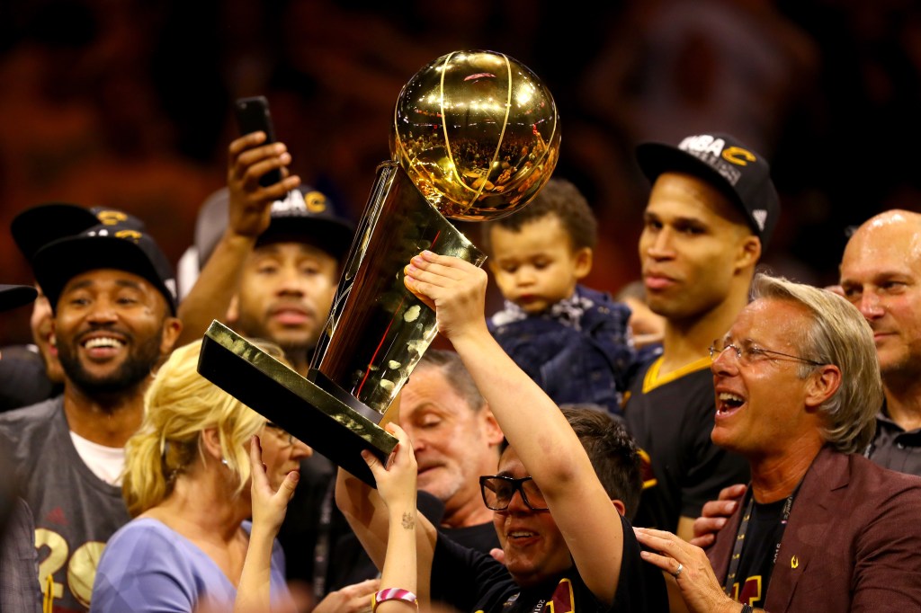 Nick Gilbert hoists the Larry O'Brien after the Cavaliers won the 2016 NBA Finals. 