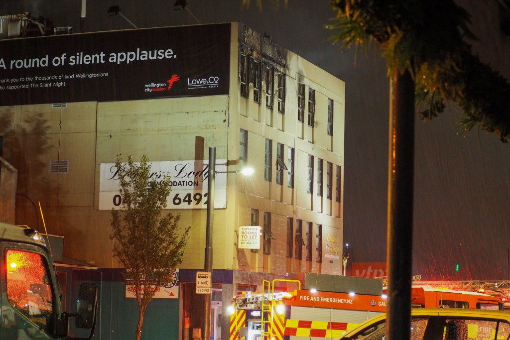 Firetrucks stage outside a fire at a hostel in central Wellington, New Zealand