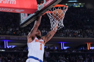 Obi Toppin slams home an alley-oop dunk during the Knicks second-quarter blitz in their 112-103 Game 5 win over the Heat.