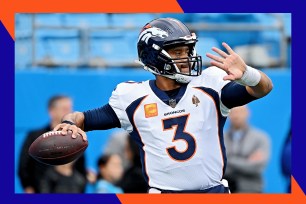 Broncos quarterback Russell Wilson drops back to throw a pass.