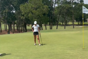 Division III golfer looks at the ball in disappointment as it rolls right back to her feet on the questionable sixth role.