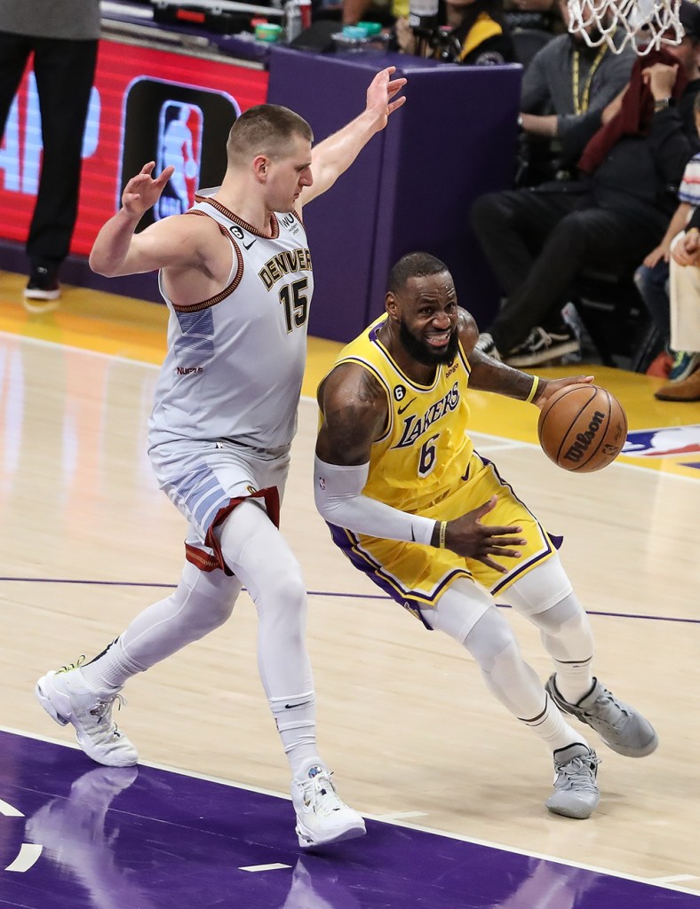 Lakers forward LeBron James (6) drives past Denver Nuggets center Nikola Jokic (15) in Game 4 of the NBA Western Conference Finals on May 22, 2023, at Crypto.com Arena in Los Angeles, CA.  