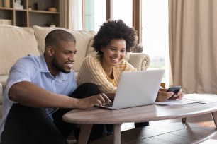 A happy couple smiles after finding a personal loan online