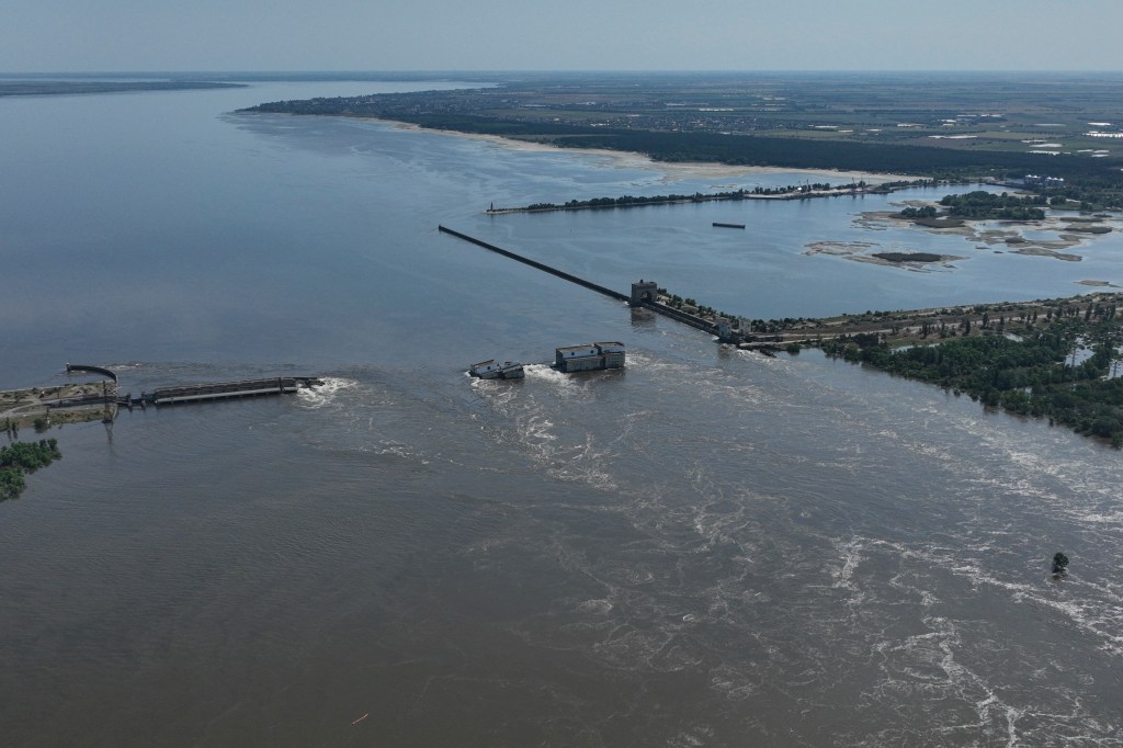 Water flows over the collapsed Kakhovka Dam in Nova Kakhovka, in Russian-occupied Ukraine, on June 7, 2023. 