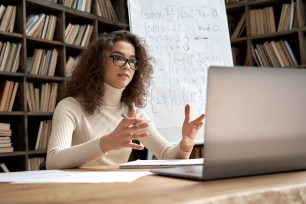 A young woman teaches math in a virtual class.