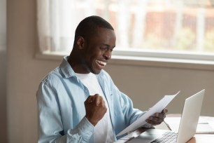 A young man celebrates his repaid student loans.