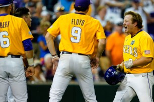 Cade Beloso (right) celebrates with teammates after belting the game-winning solo homer in the 11th inning of LSU's 4-3 win over Florida in Game 1 of the College World Series.