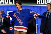 Gabriel Perreault puts on a Rangers sweater after being picked in the first round with the No. 23 overall pick.