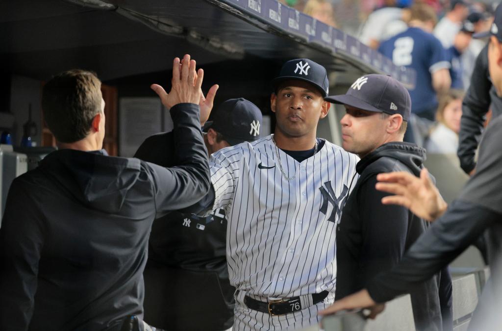 Jhony Brito accepts congratulation from teammates after exiting the game in the sixth inning in which he didn't allow a run in the Yankees' 4-1 win over the Mariners on June 21.