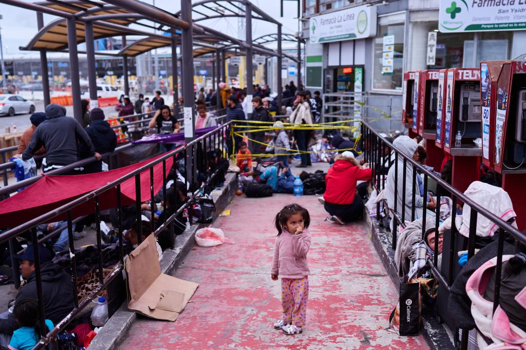 Children brave the cold and days-long wait with their parents in hopes of gaining entry into the US.