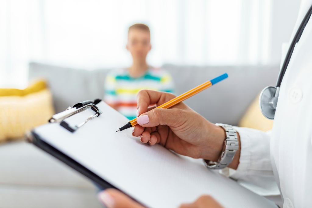 Doctor taking notes on young patient