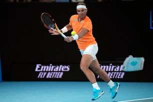 Rafael Nadal, of Spain, plays a backhand return to Mackenzie McDonald, of the U.S., during their second-round match at the Australian Open tennis championship in Melbourne, Australia, Jan. 18, 2023.