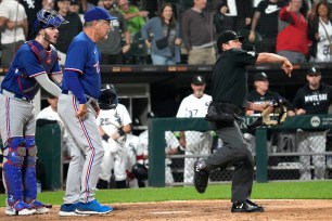 Texas Rangers catcher Jonah Heim, left, reacts after manager Bruce Bochy, center, was ejected by home plate umpire DJ Reyburn during the eighth inning of the team's baseball game against the Chicago White Sox in Chicago, Tuesday, June 20, 2023.