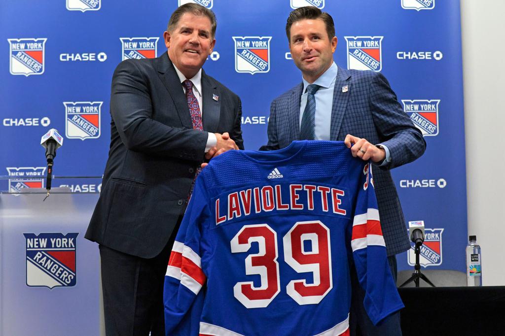 The New York Rangers GM Chris Drury (right), and Rangers new head coach Peter Laviolette, holding a jersey as they pose for a photo during a press conference where Laviolette was introduced as the Rangers new head coach, at the Rangers practice facility in Tarrytown, New York. 