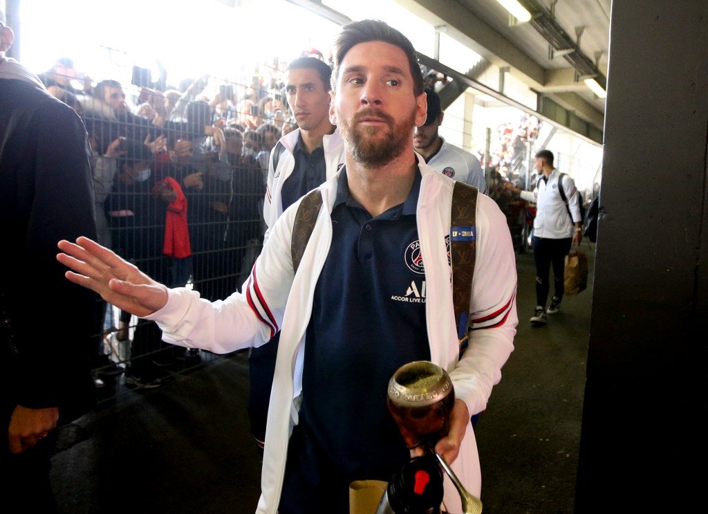 Lionel Messi, Angel Di Maria (left) of PSG interact with fans.