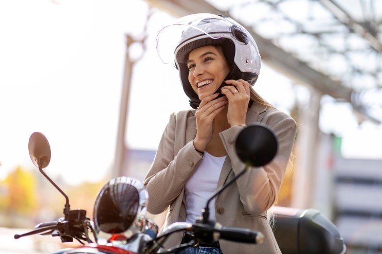 Woman on a motorcycle she paid for using a loan