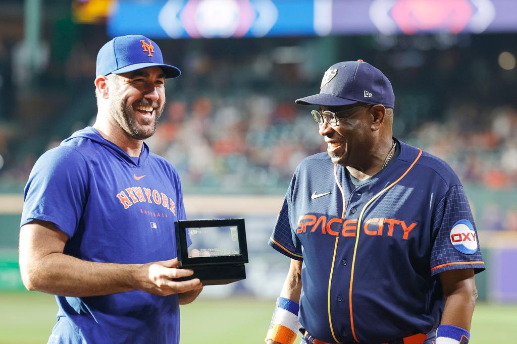 Justin Verlander #35 of the New York Mets receives his World Series ring from Dusty Baker Jr. #12 of the Houston Astros at Minute Maid Park on June 19, 2023 in Houston, Texas. 