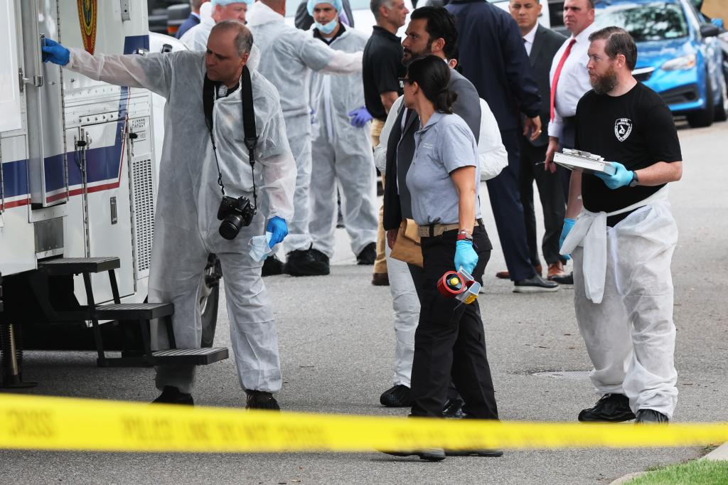 Law enforcement officials are seen as they investigate the home of a suspect arrested in the unsolved Gilgo Beach killings on July 14, 2023 in Massapequa Park, New York. 