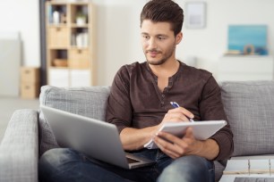 A young man calculates his graduate school loan.