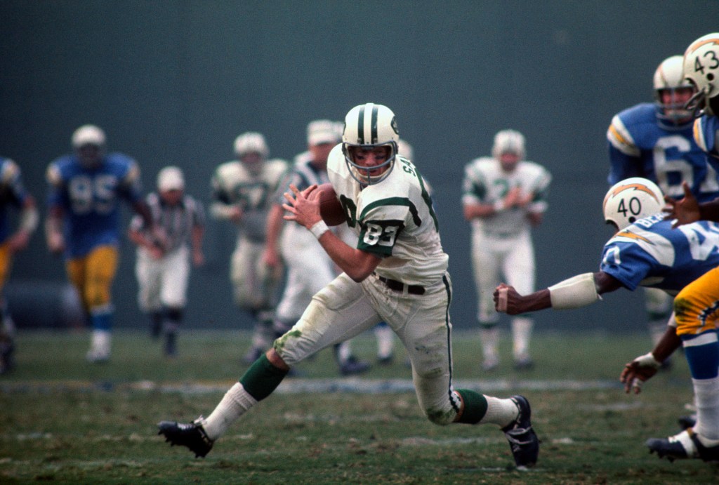 George Sauer looks to avoid the tackle of Joe Beauchamp of the San Diego Chargers during an NFL football game in 1967.