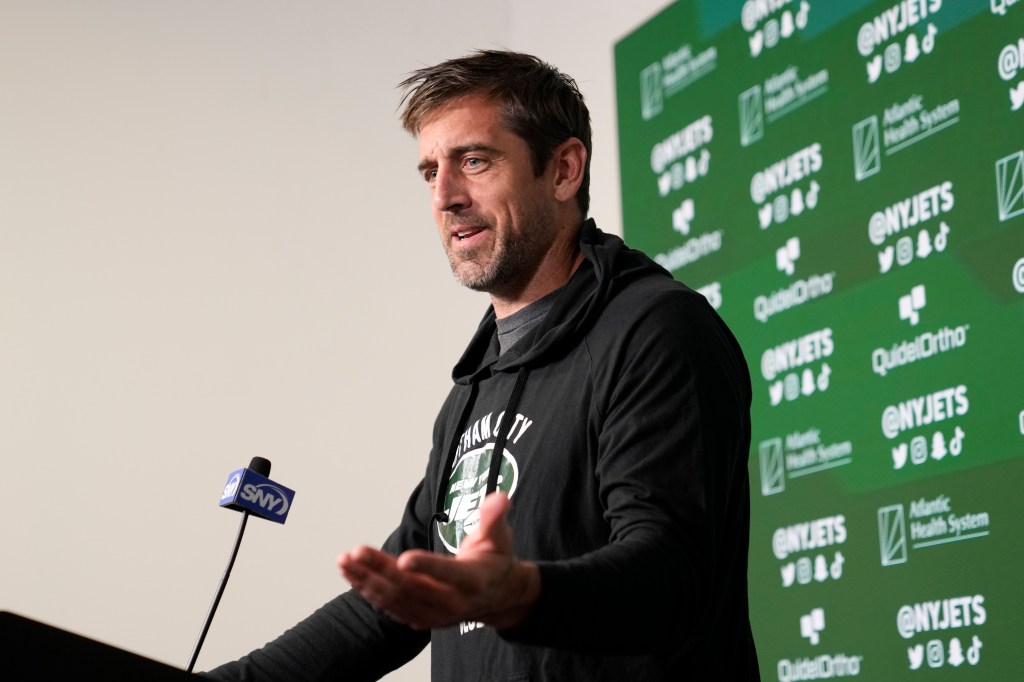 Aaron Rodgers speaks to members of the media at the NFL football team's practice facility.