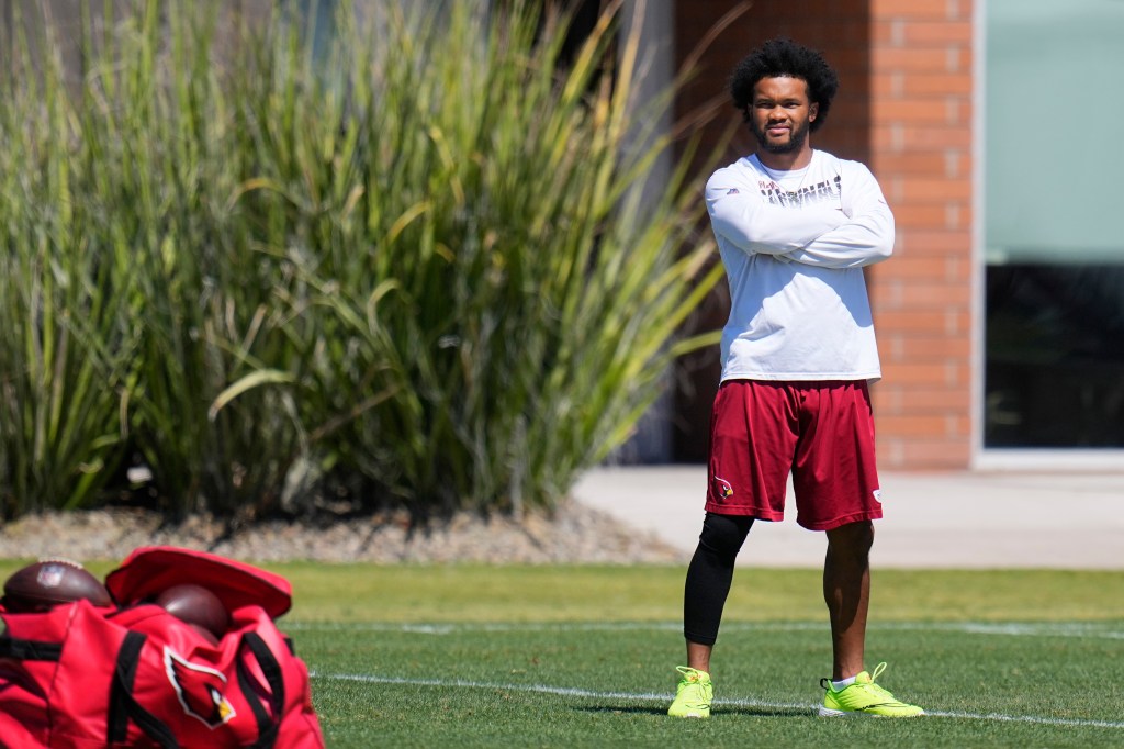 Kyler Murray watches teammates during practice.