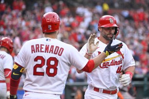 Paul Goldschmidt (46) is congratulated by Nolan Arenado (28). 