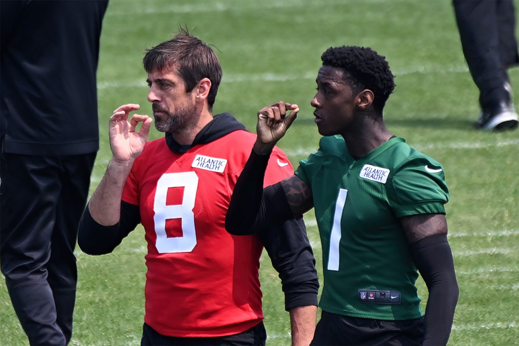 Aaron Rodgers, shown practicing a handshake with cornerback Sauce Gardner, has resembled a quarterback who wants to play for the Jets, as opposed to Brett Favre.