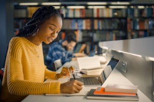 Student in library after learning how to pay loans with a credit card