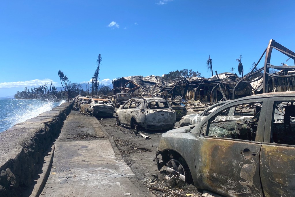 Burned cars and destroyed buildings are pictured in the aftermath of a wildfire in Lahaina, western Maui, Hawaii on August 11, 2023.