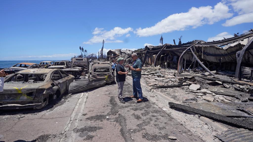 Governor of Hawaii Josh Green, left, and Maui County Mayor Richard Bissen, Jr., speak during a tour of wildfire damage on Saturday, Aug. 12, 2023, in Lahaina, Hawaii.