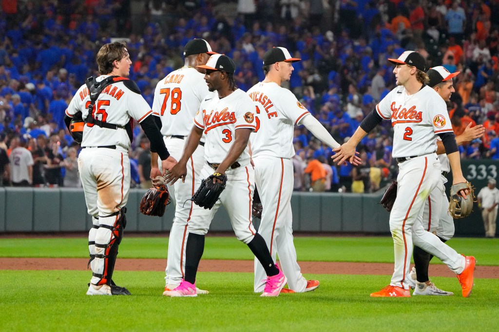 The Orioles celebrate the victory after the ninth inning against the New York Mets.