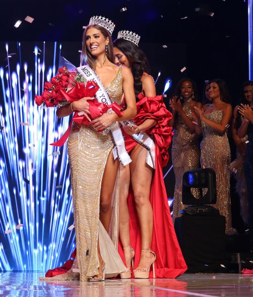 Rachel di Stasio smiles at the pageant with her crown and a bouquet of roses.