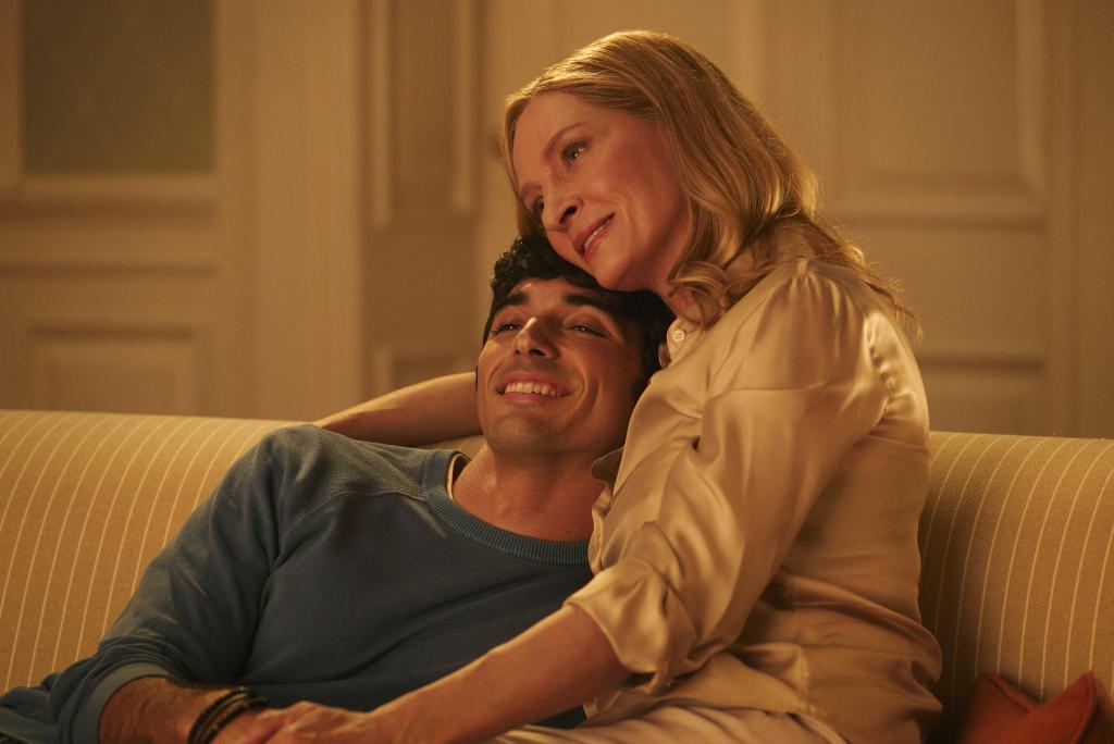 Alex (Taylor Zakhar Perez) and his mom, President Claremont (Uma Thurman) cuddle on a couch. 