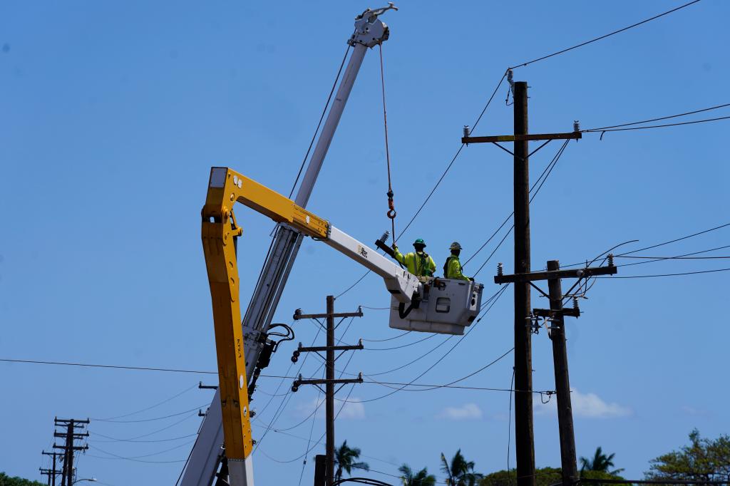 Linemen work on power lines in Lahaina on Sunday.