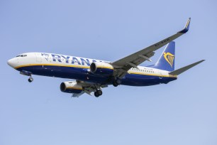 Ryanair plane in sky.