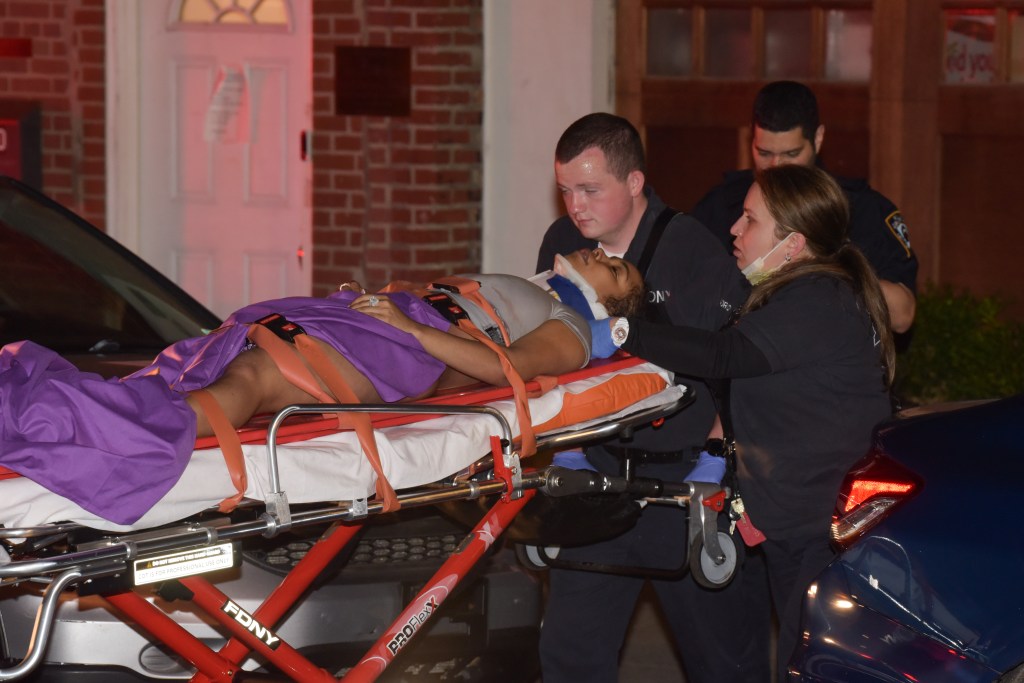 EMS workers remove a victim on a stretcher from the scene of the crash at Atlantic Avenue and Court Street.