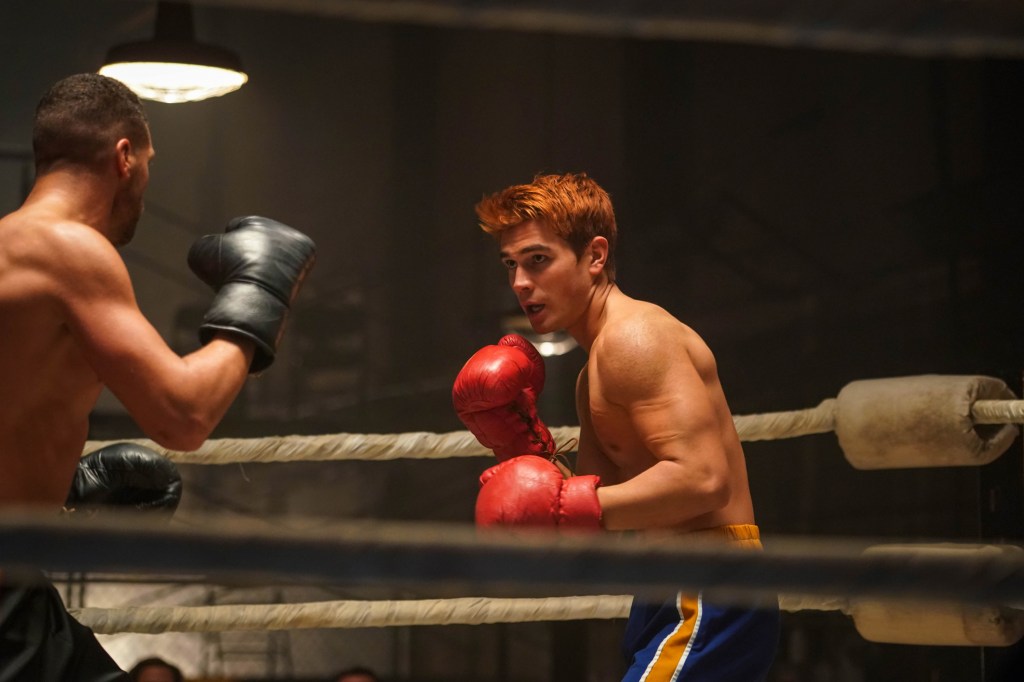 KJ Apa in boxing gloves, shirtless. 