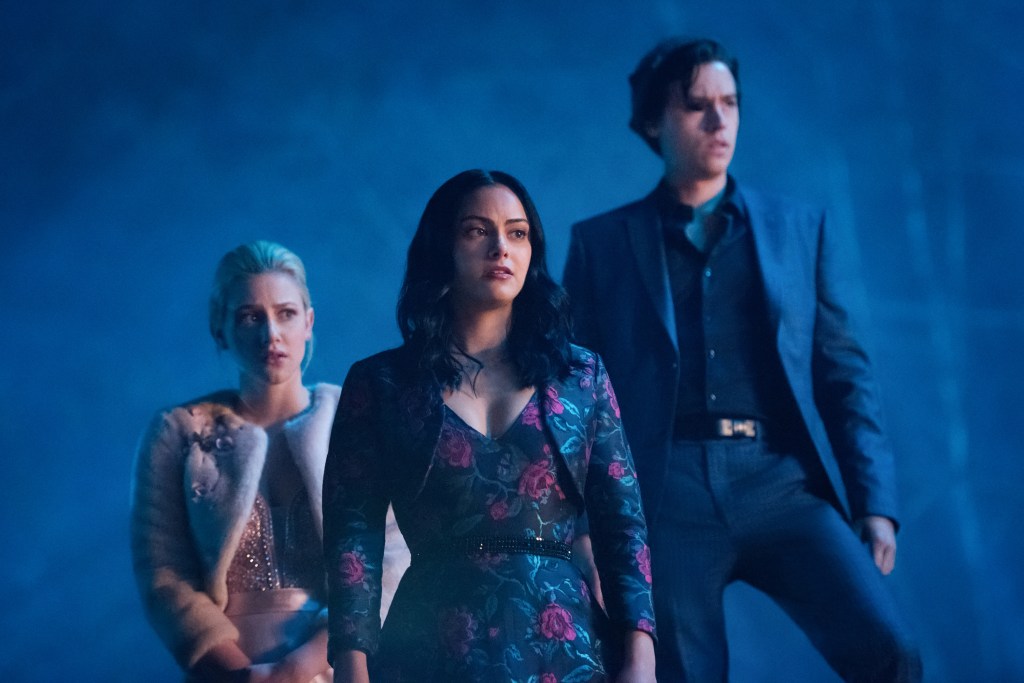 Lili Reinhart as Betty, Camila Mendes as Veronica and Cole Sprouse as Jughead looking anxious. 