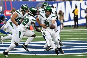 Aaron Rodgers hands the ball off to Michael Carter during their preseason game against the Giants.