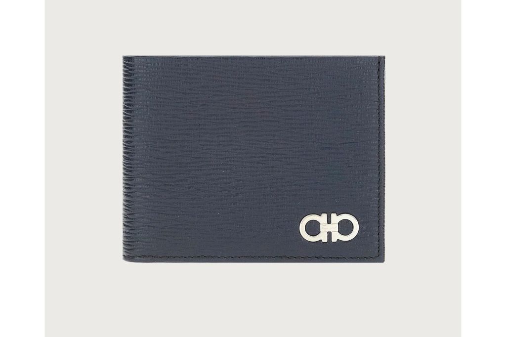 A navy blue wallet with gold hardware.