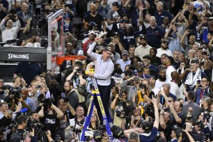 Head coach Dan Hurley of the Connecticut Huskies reacts as he cuts down the net after defeating the San Diego State Aztecs 76-59 during the NCAA Men's Basketball Tournament National Championship game.