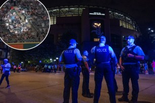 Chicago Police officers stand outside Guaranteed Rate Field.