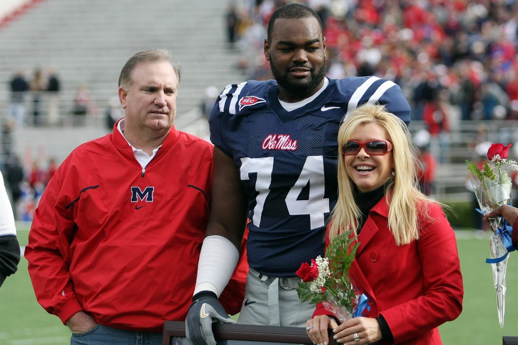 Michael Oher (center) stands with his family during his time at Ole Miss in 2008.