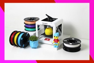 White 3-D printer surrounded by a colorful border.