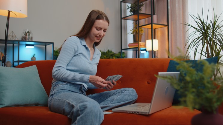 A woman calculates how much $1,000 could earn in a savings account.