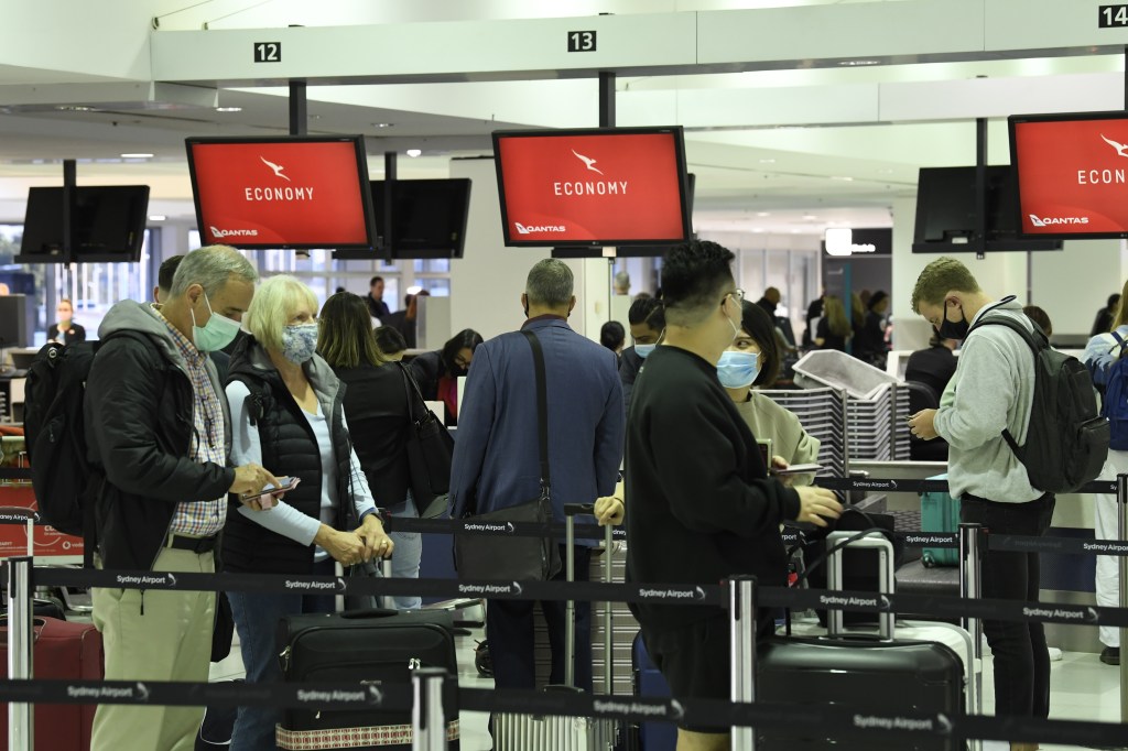 Passengers lining up to check in for Qantas flight 