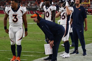 Denver Broncos quarterback Russell Wilson (3), left, walks past his Head Coach Sean Payton