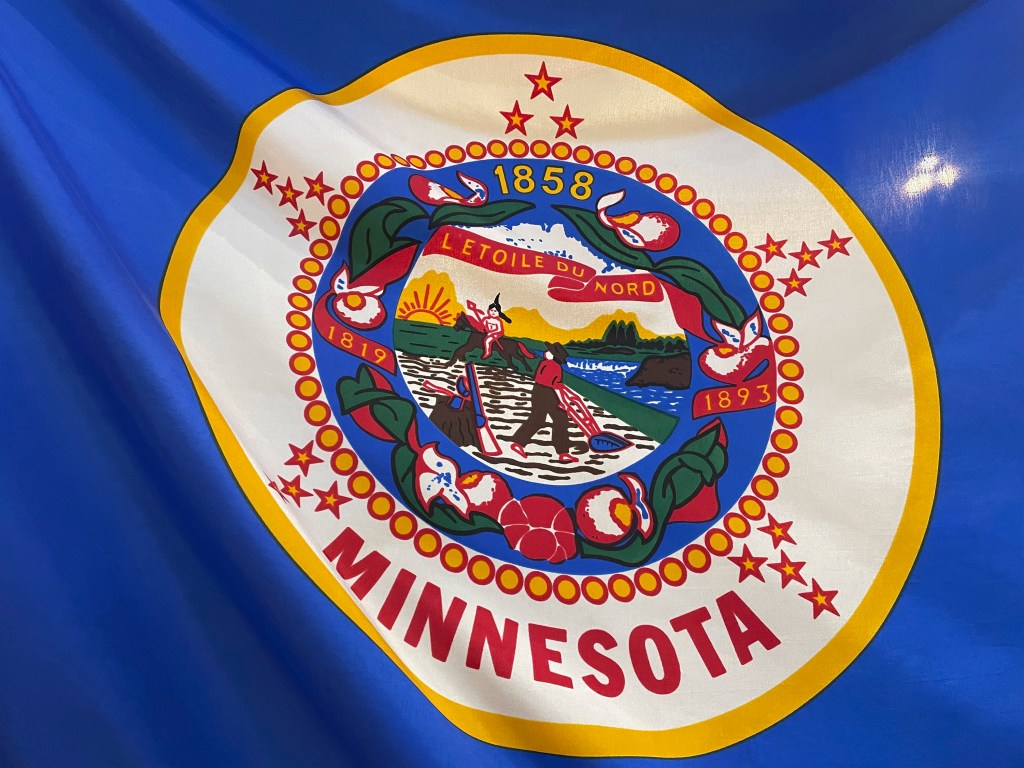 The Minnesota state flag is under renovation due to Native American concerns. 