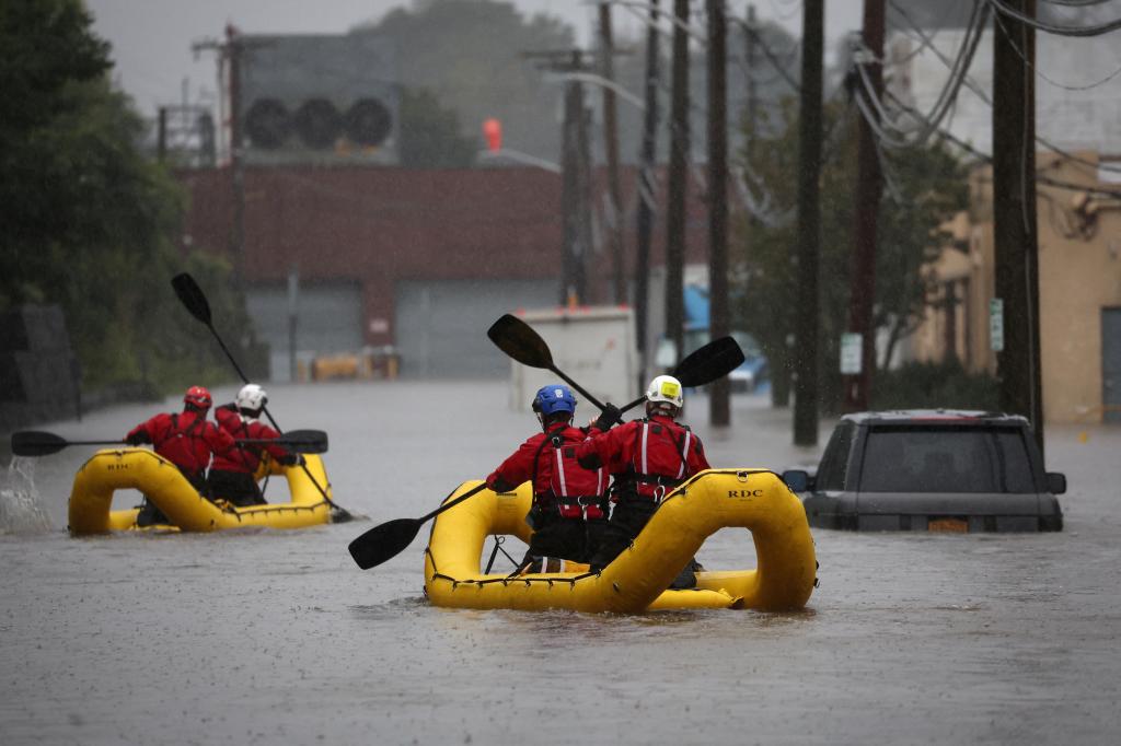 Special Operations Unit rescue personnel with the Westchester County Emergency Services paddle in rafts as they check buildings for victims trapped in heavy flooding in the New York City suburb of Mamaroneck, New York.